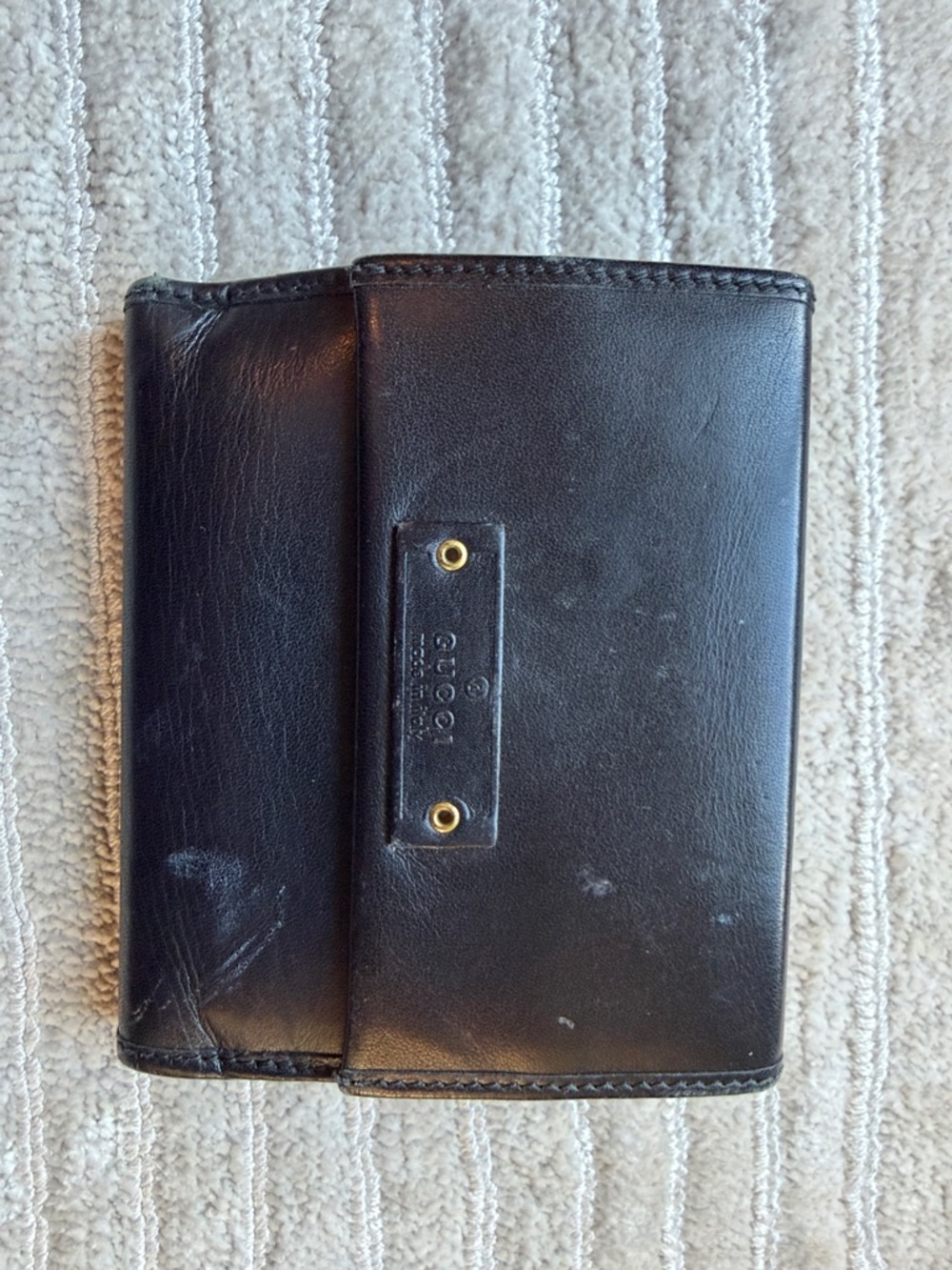 Gucci Black Leather Trifold Wallet with Gold Accents